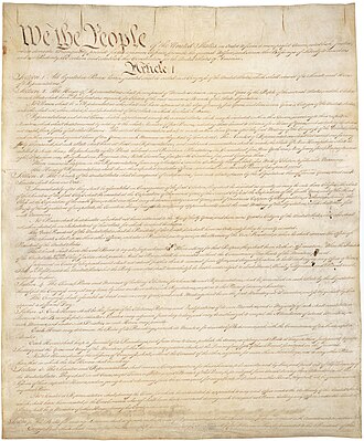 The U.S. Constitution displayed on parchment, framed by the Bill of Rights.