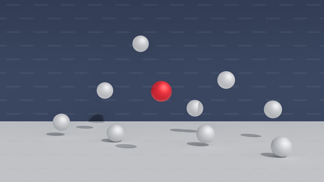 A red sphere surrounded by white spheres.
