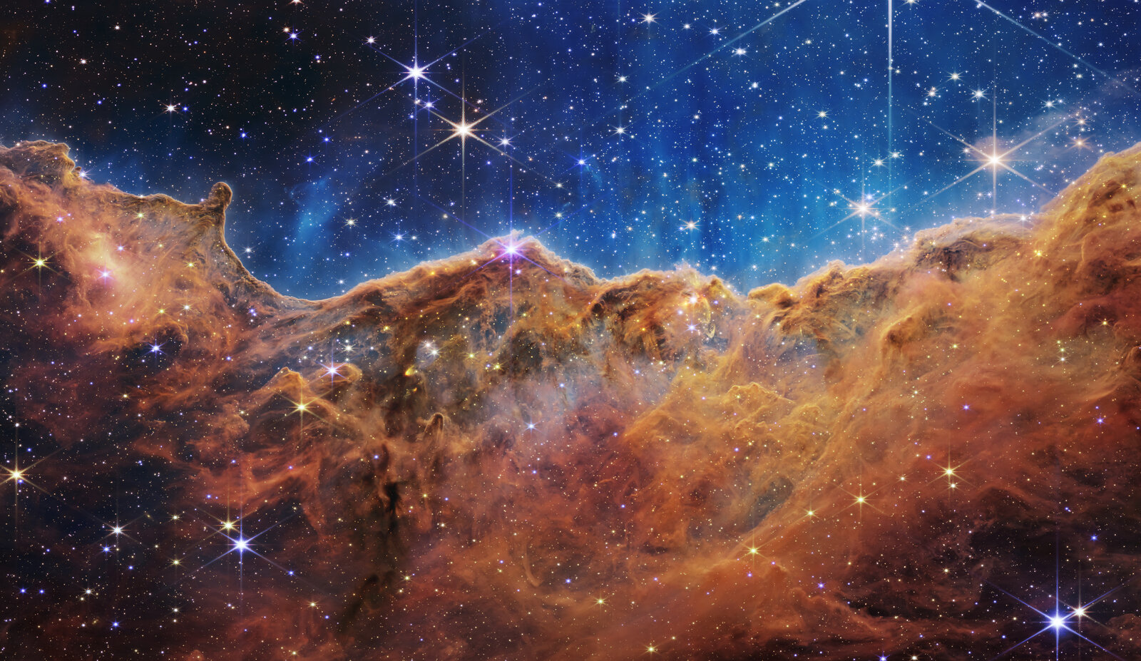 Cosmic Cliffs in the Carina Nebula (NGC 3324) — one of JWST's first-light images, revealing star formation in unprecedented infrared detail