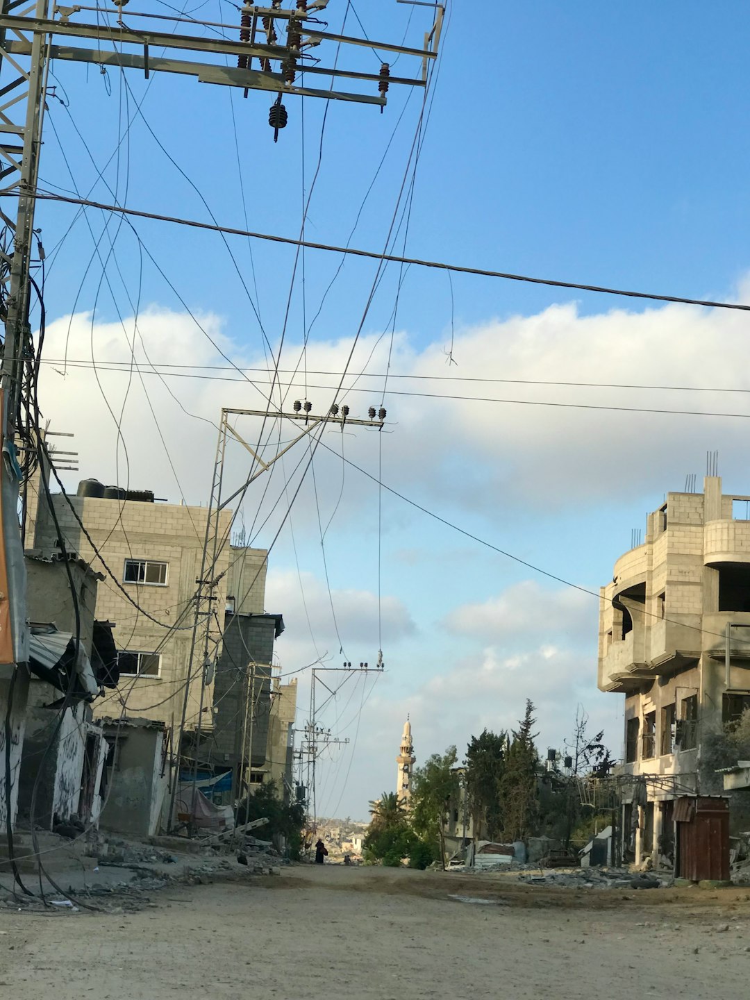 A city street with buildings and power lines