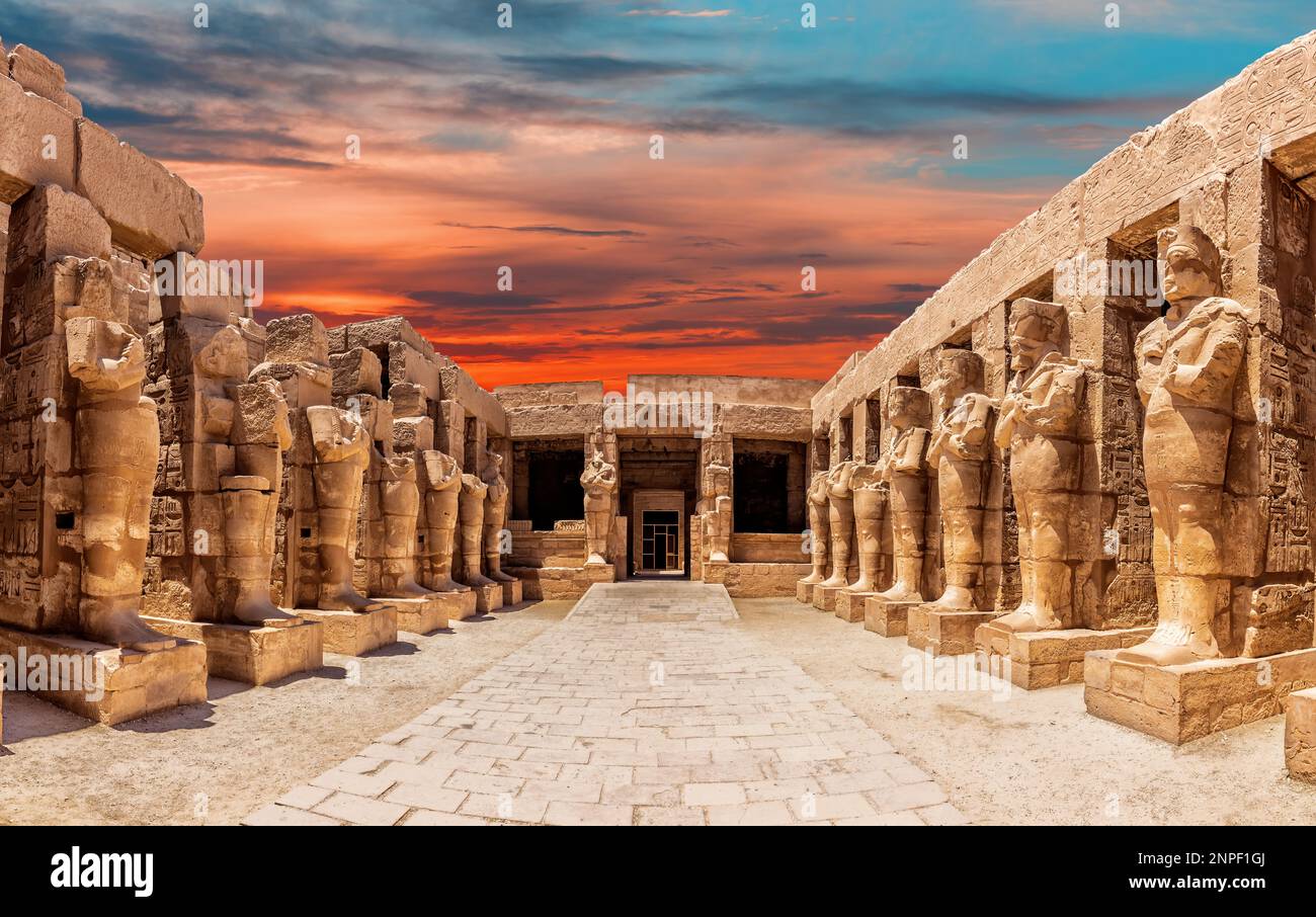 Statues of the Great Temple of Amun at sunset, Karnak …